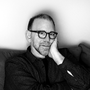 Black and white portrait of man with hand on face.