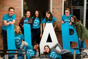 A group of students posing with large letters that say U. A. B.