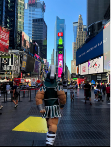 Exterior Photograph of Sparty Mascot walking in Times Square