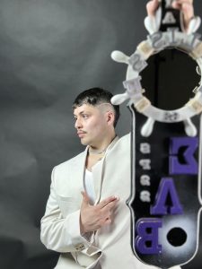 A person poses with a banner