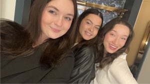 Three students pose for a selfie