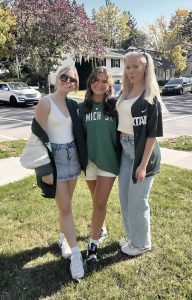 Three people pose for a photograph