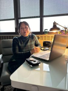 A faculty member sitting at a desk