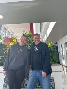 Two people pose for a photograph.