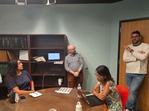 People discuss a topic in a room with a conference table