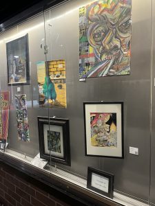 A group of images on a wall at an art gallery
