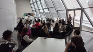 A group of students, faculty and international artists pose in between working
