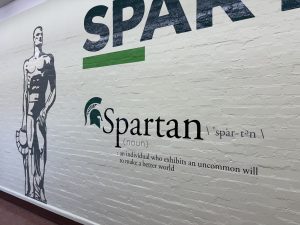 A mural outside of an office that says "Spartan"