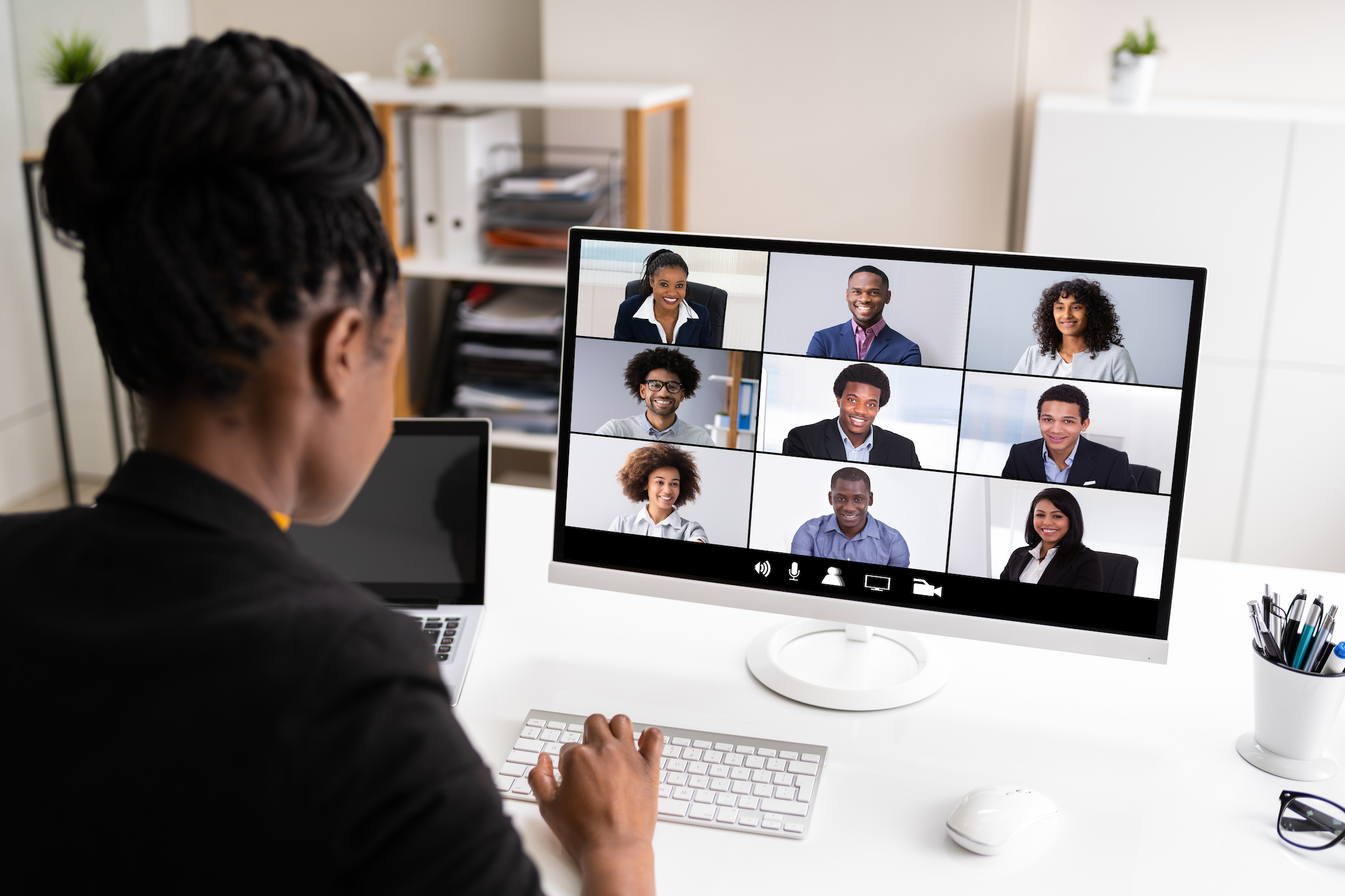 Woman with braids in a work call at home.