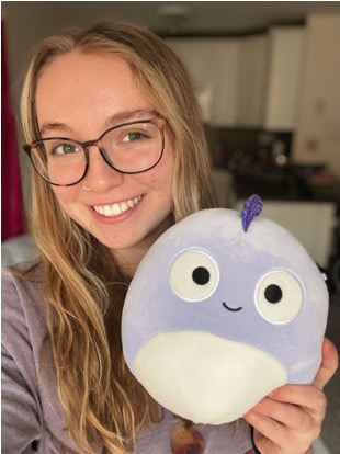 Student hugging squishmallow