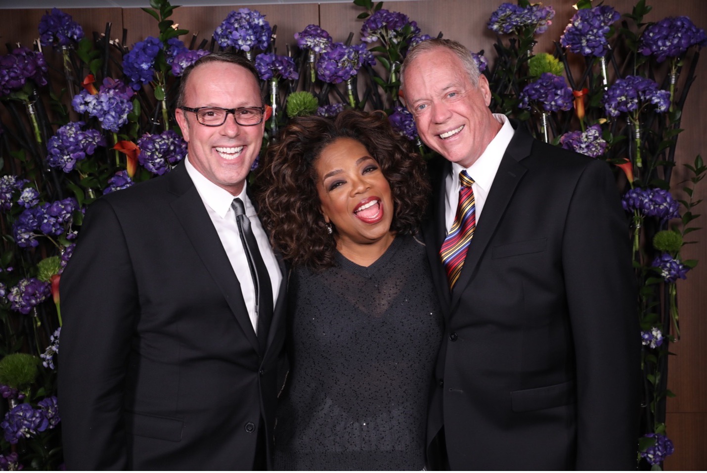 Three people pose for a photograph