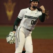 A picture of a woman on the Michigan State University softball team playing