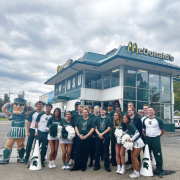 Outside of a McDonald's restaurant, a group of students pose with Michigan State University mascot, Sparty.