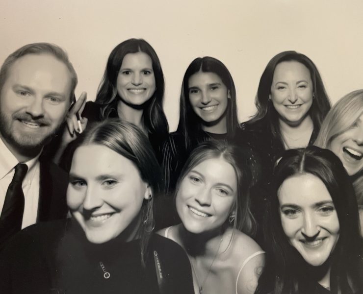 Many people smile while posing for the camera.