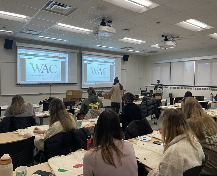 Students work at an event in a classroom