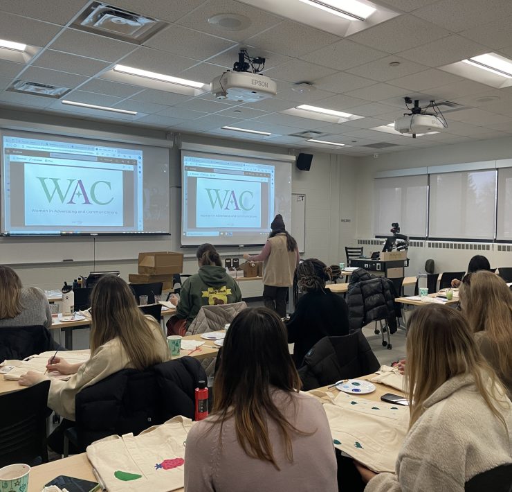 Students work at an event in a classroom