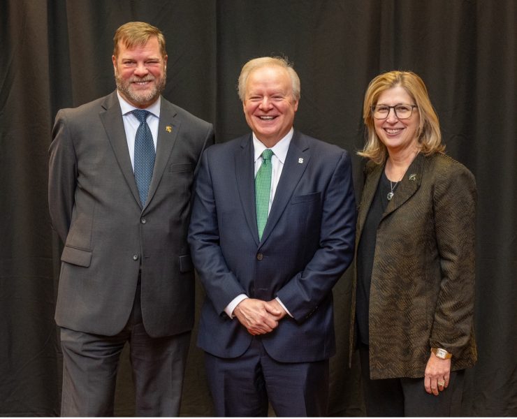 Three people pose for a portrait