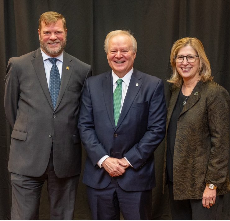 Three people pose for a portrait