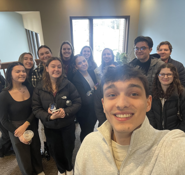 A plethora of students smiling on an agency tour