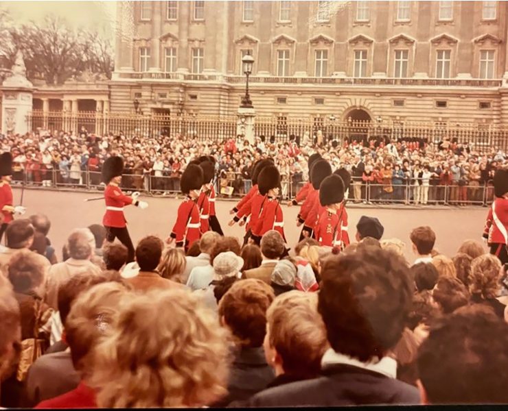 A crowd watches the British Royal Guards march
