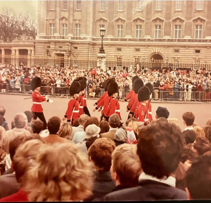 A crowd watches the British Royal Guards march