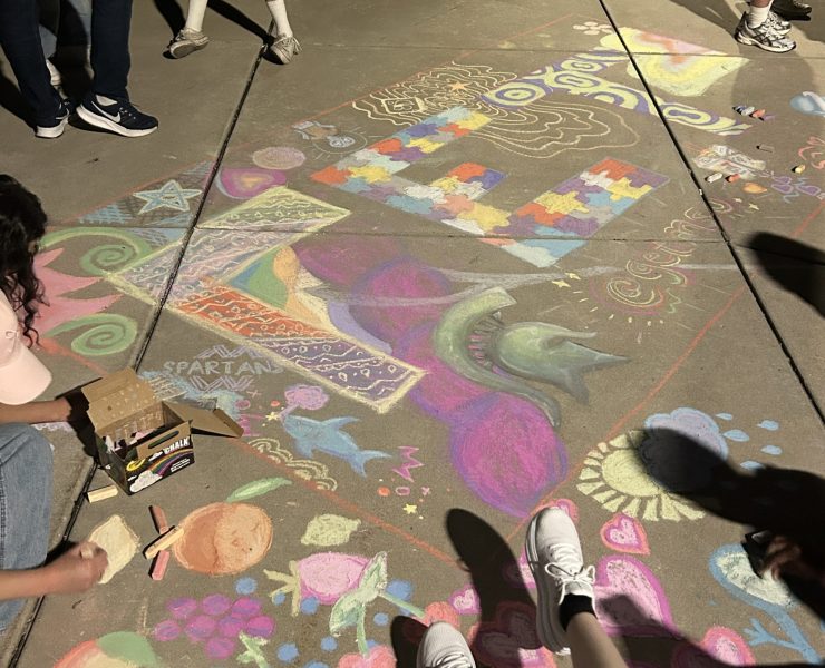 Sidewalk is colorfully decorated with sidewalk chalk