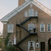 A photograph of a wedding engagement on the side of a building