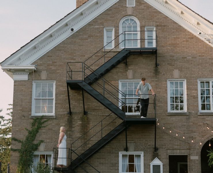 A photograph of a wedding engagement on the side of a building