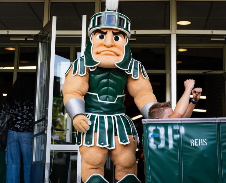 MSU mascot Sparty pushing a cart.