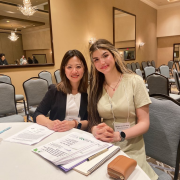 Two people smiling sitting at a table
