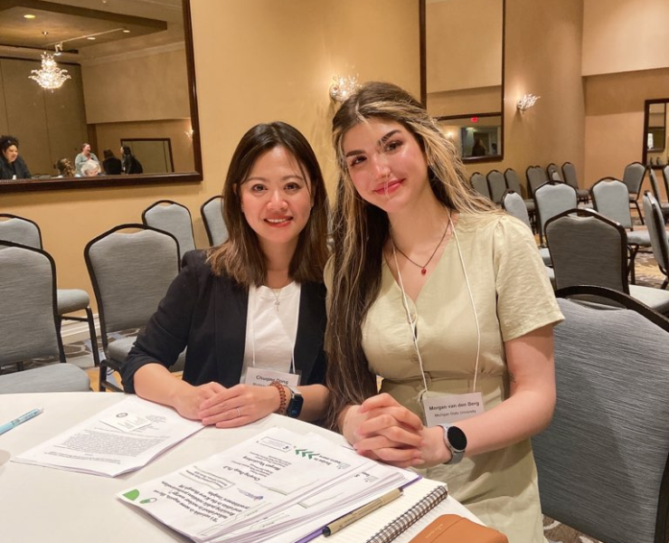 Two people smiling sitting at a table