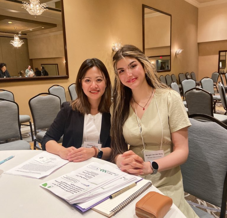 Two people smiling sitting at a table