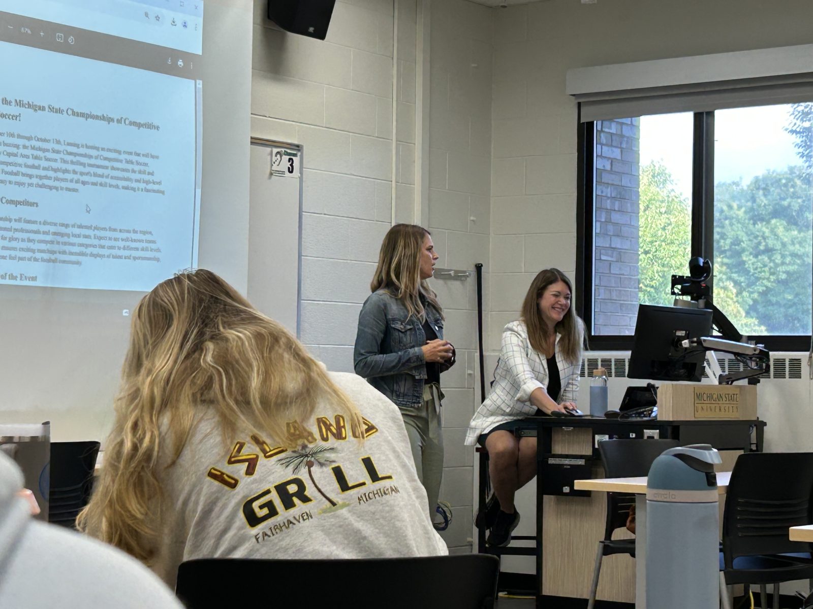 A faculty member speaks to a group of students