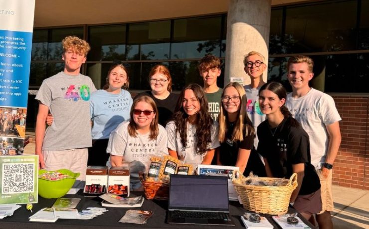A group of students pose in front of the Wharton Center
