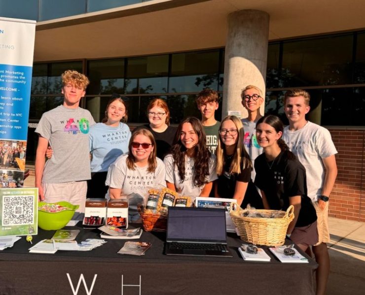 A group of students pose in front of the Wharton Center
