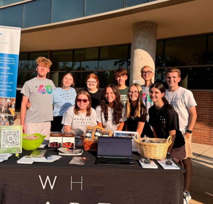 A group of students pose in front of the Wharton Center