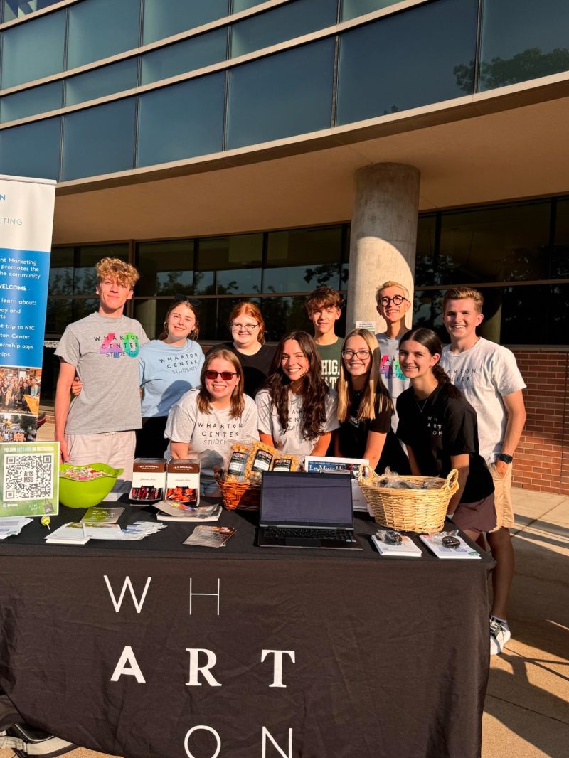 A group of students pose in front of the Wharton Center