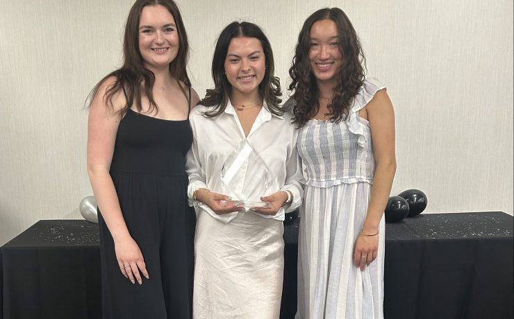 Three students pose for a picture.