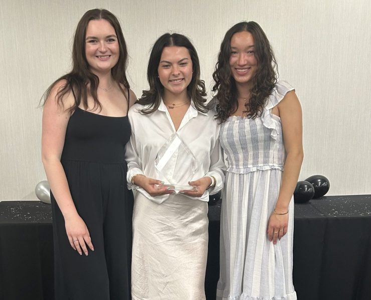 Three students pose for a picture.