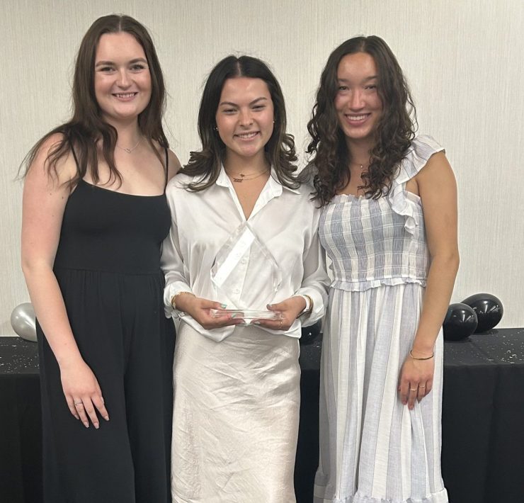 Three students pose for a picture.