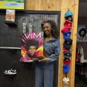 Portrait of a smiling student holding a poster