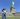 A person poses in front of the Statue of Liberty