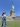 A person poses in front of the Statue of Liberty