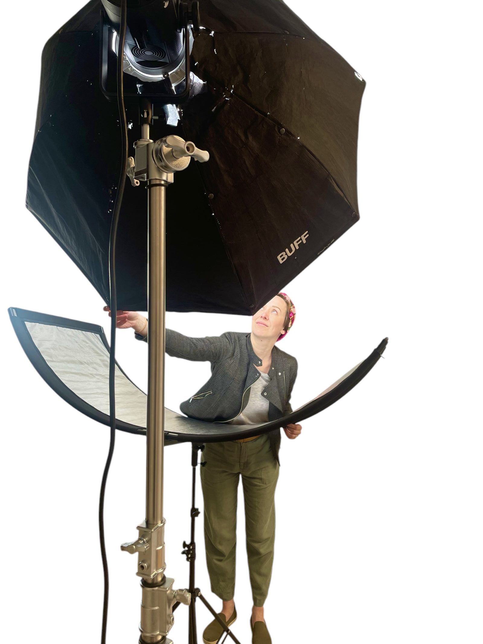 A person adjusts lighting in a photo studio.