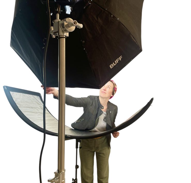 A person adjusts lighting in a photo studio.