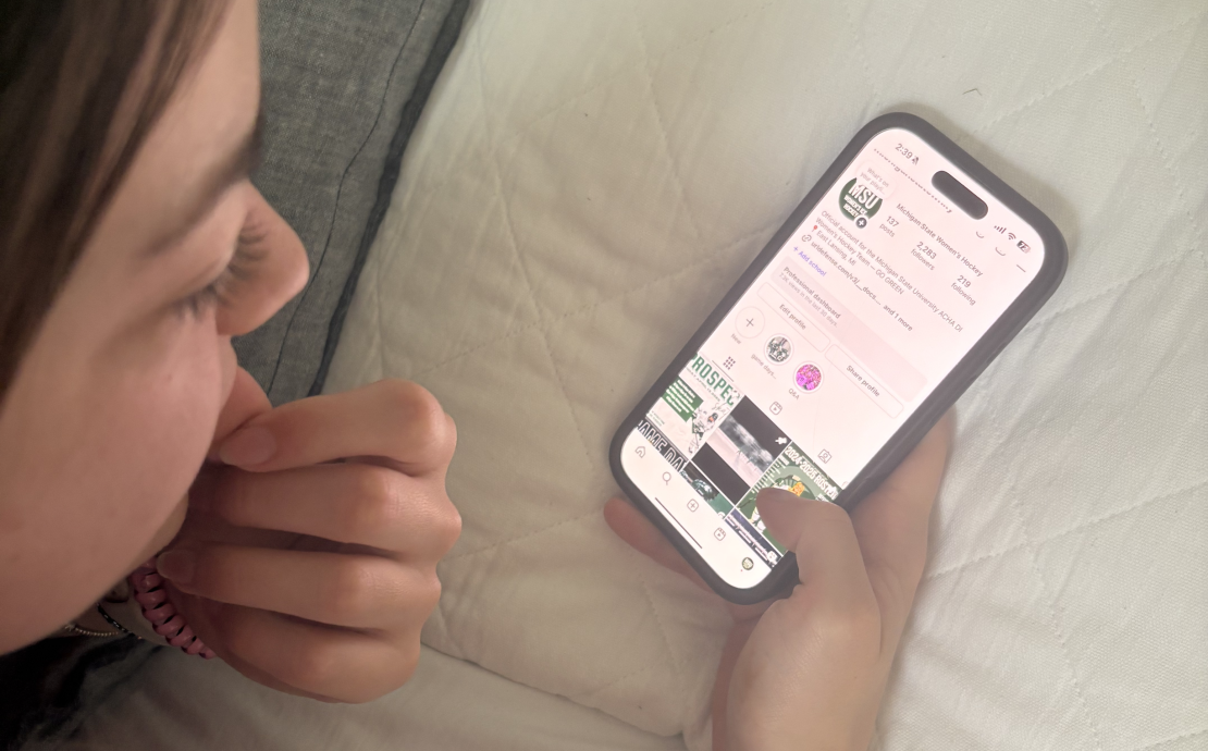 A person looks at a web app on a phone screen