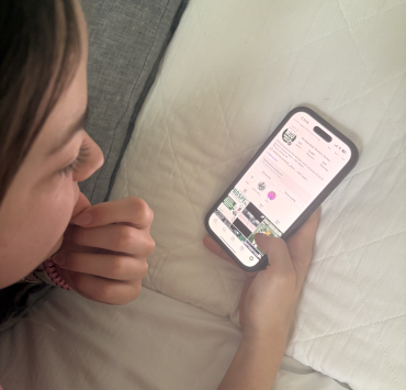 A person looks at a web app on a phone screen