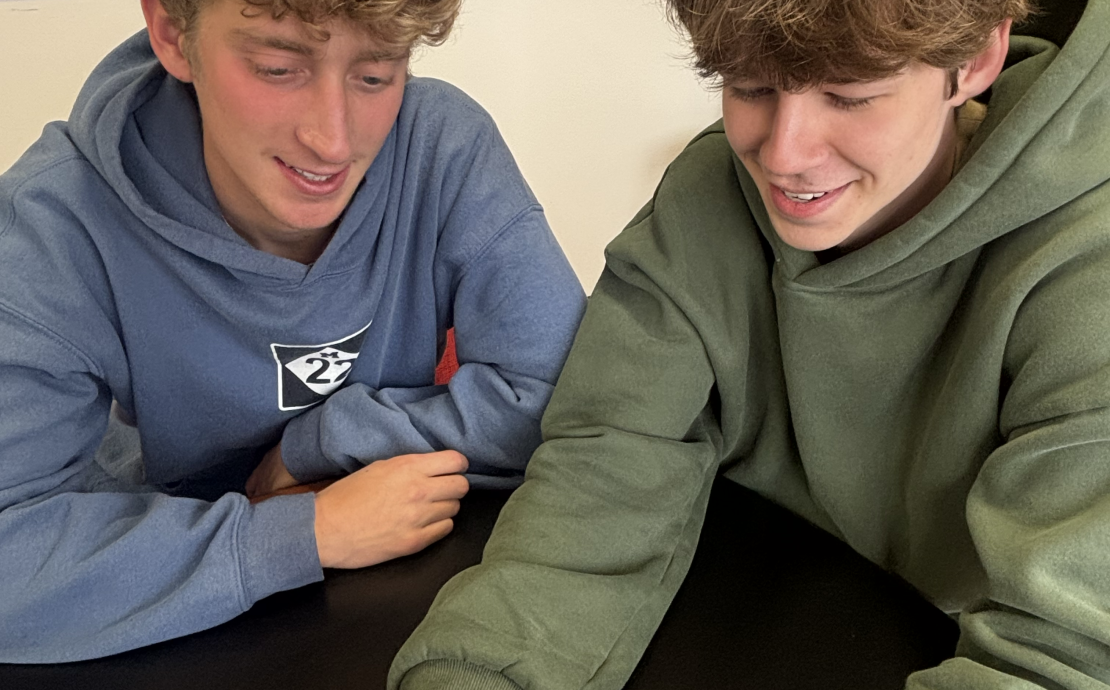 Two people look at a phone screen together