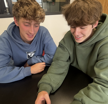 Two people look at a phone screen together