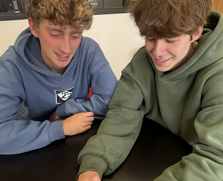 Two people look at a phone screen together